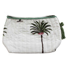 Palm tree print wash bag on white background with green pom pom trim cut out.