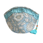 Cornflower blue wash bag with turquoise trim and tassel on a white background