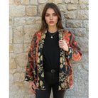 Quilted reversible jacket with gold floral pattern.