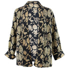 Floral and geometric patterned shirt on a white background