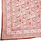 Pink and red reversible quilted throw in floral print.