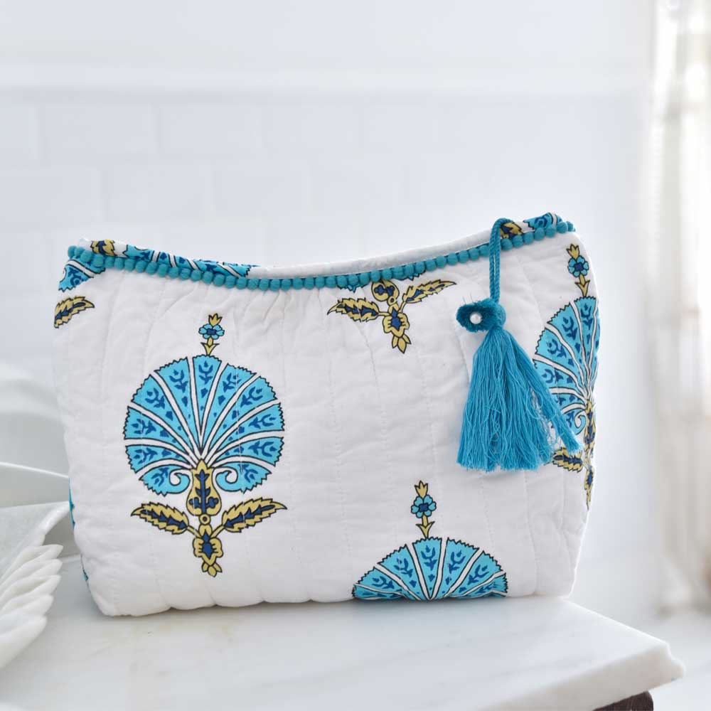 White wash bag with blue shell print and tassel.