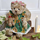 Fluffy teddybear in a gingerbread printed green dress.