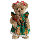 Super soft and cuddly teddy bear wearing a green dress with gingerbread design on a white background