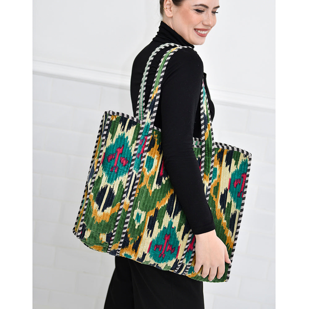 Velvet ikat shopping bag lifestyle over woman's shoulder