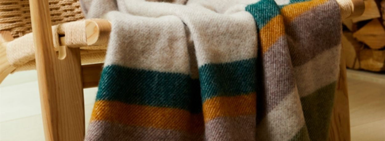 New season striped new wool blanket draped over a wooden chair at The Black Faced Sheep