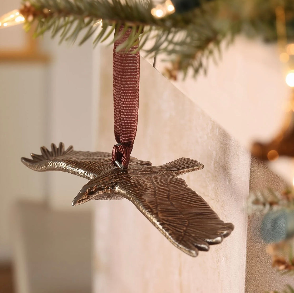 Brass buzzard-shaped hanging ornament.