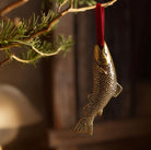 Brass fish-shaped hanging Christmas ornament.