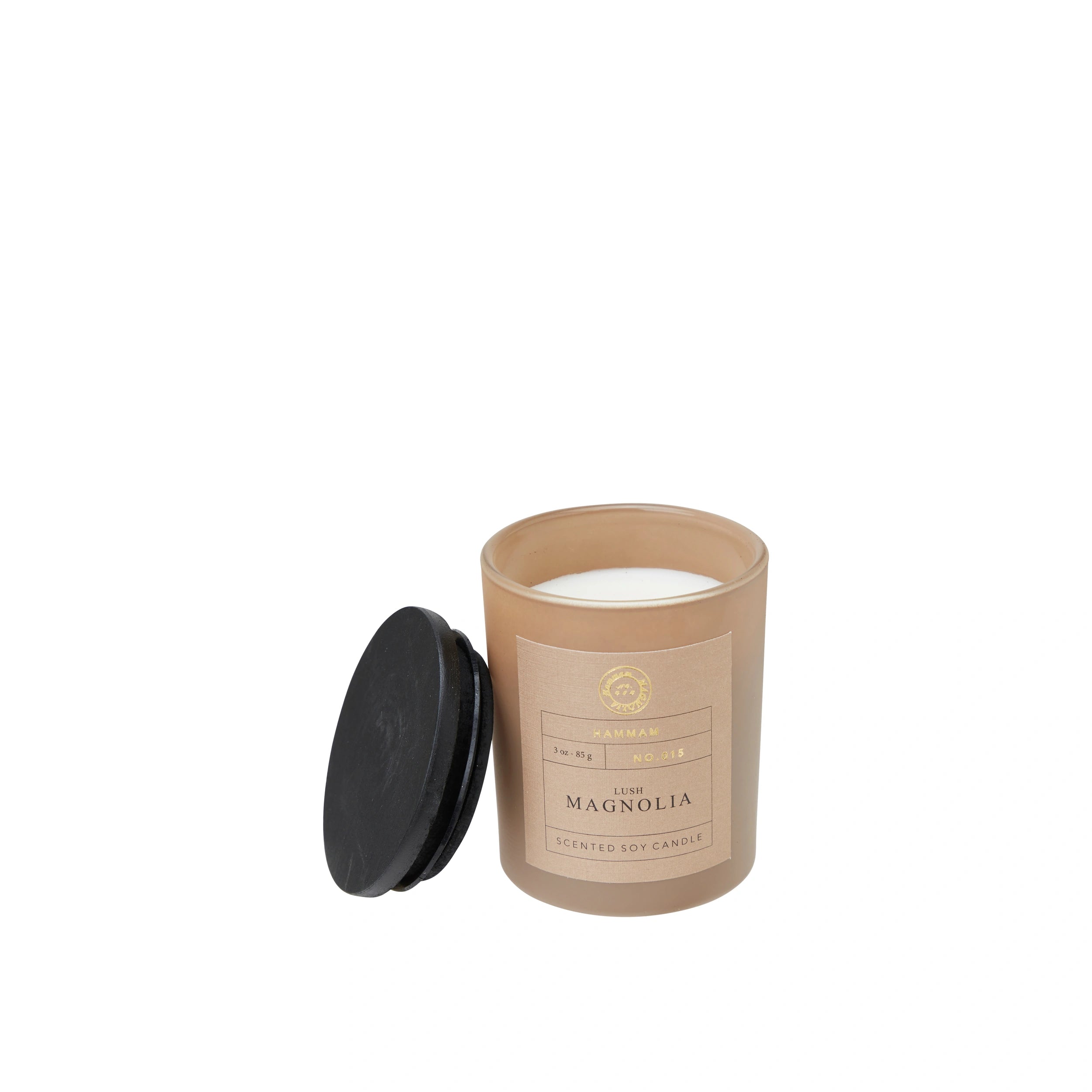 Candle in brown jar with 'Hammam Lush Magnolia' label.