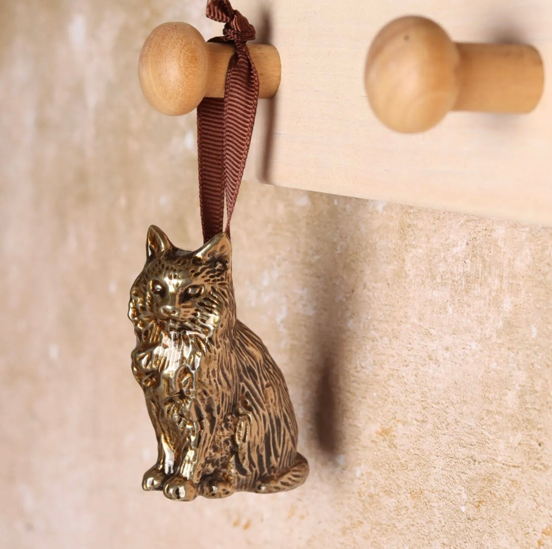 Brass cat-shaped hanging decoration.