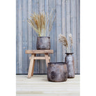 Wooden stool with decorative vases.