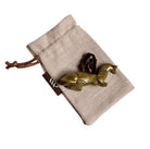 Brass otter-shaped hanging Christmas ornament on linen gift bag.