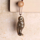 Brass owl shaped hanging decoration.