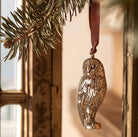 Brass owl shaped hanging decoration.