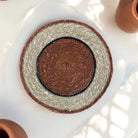 Orange round woven placemat.