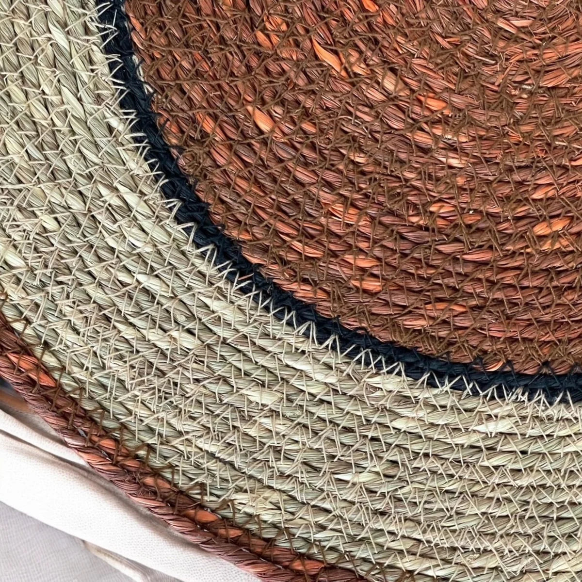Detail of round woven seagrass placemat.