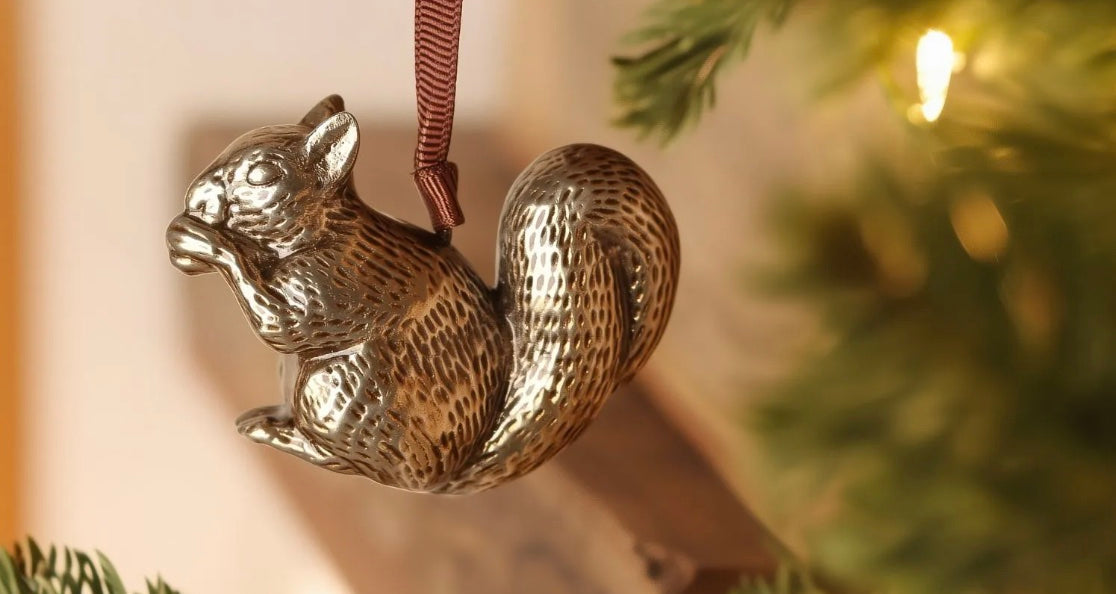 Brass squirrel-shaped hanging ornament.