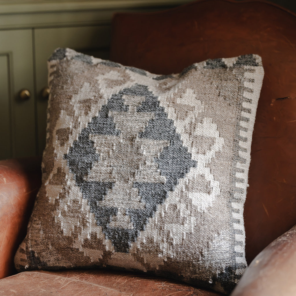 Textured sofa cushion with monochrome geometric pattern 