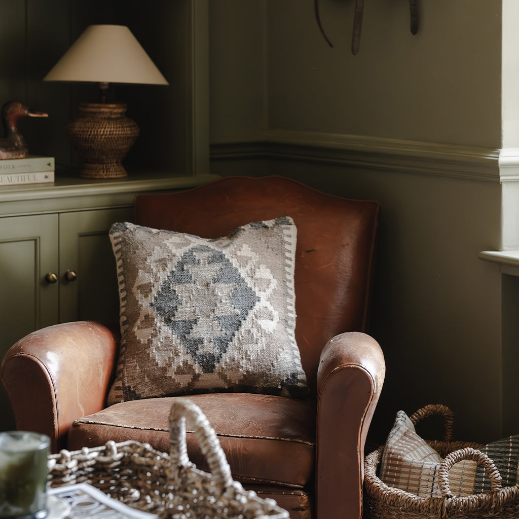Decorative sofa cushion with monochrome geometric design.