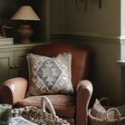 Decorative sofa cushion with monochrome geometric design.