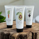 Three tubes of 'the farmer's garden' hand cream carrot, beetroot and avocado.