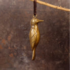 Brass woodpecker-shaped hanging ornament. 